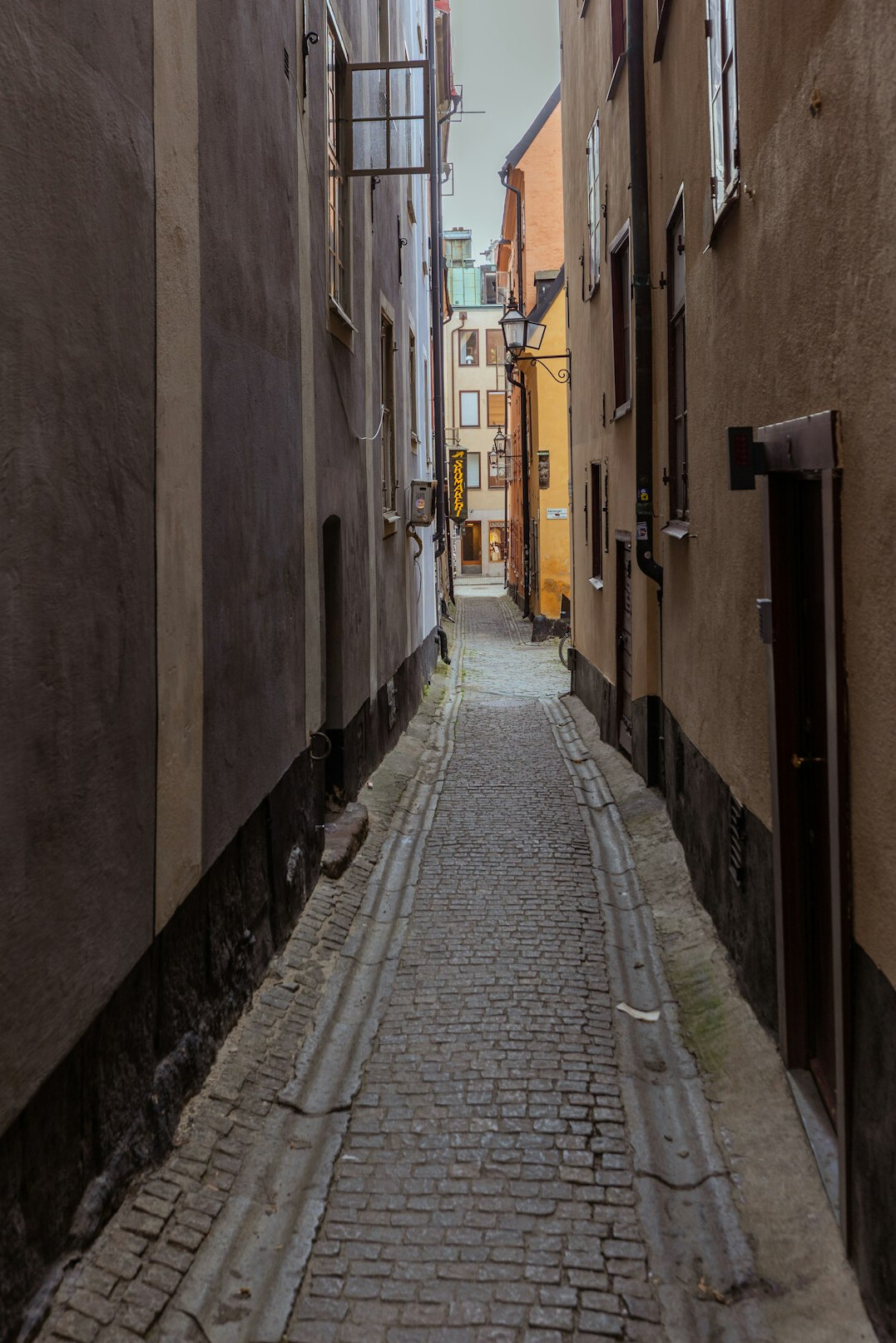 Narrow old European street with historic tenement houses