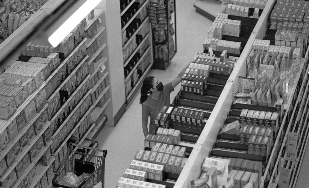 store security guard monitoring aisles