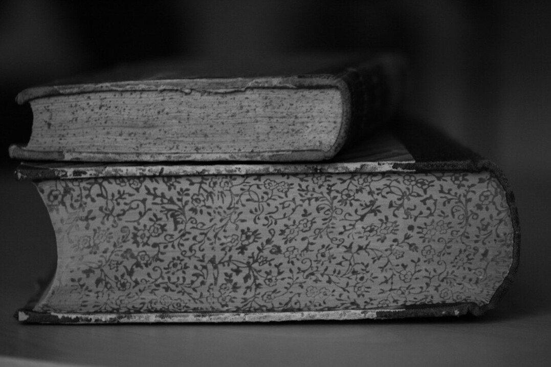 Stack of old books with worn covers